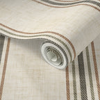 Close-up of parchment and olive stripe wallpaper roll showing textured linen-style background and classic vertical stripe detail.