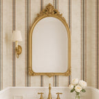 Parchment and olive stripe wallpaper styled behind an ornate mirror in a bathroom, showcasing elegant French country and heritage interior styling.