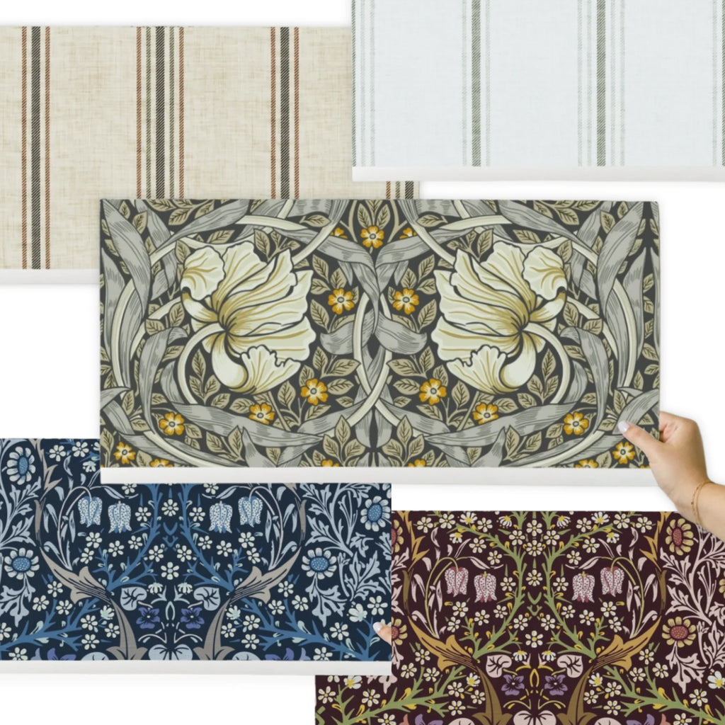 William Morris and Whimsy & Mojo wallpaper samples layered together, one held against a wall.