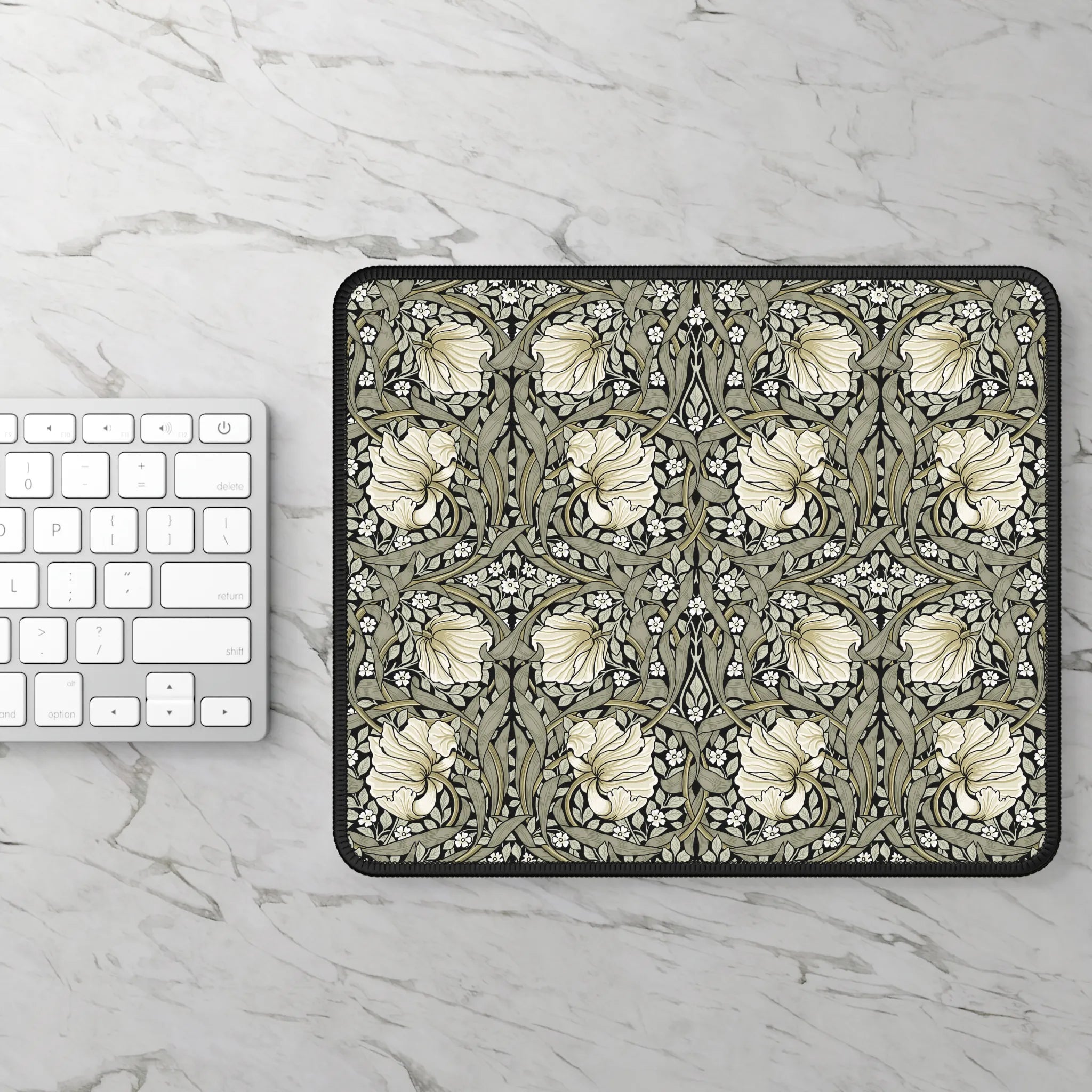 William Morris mouse pad with floral pattern on a marble surface next to a keyboard