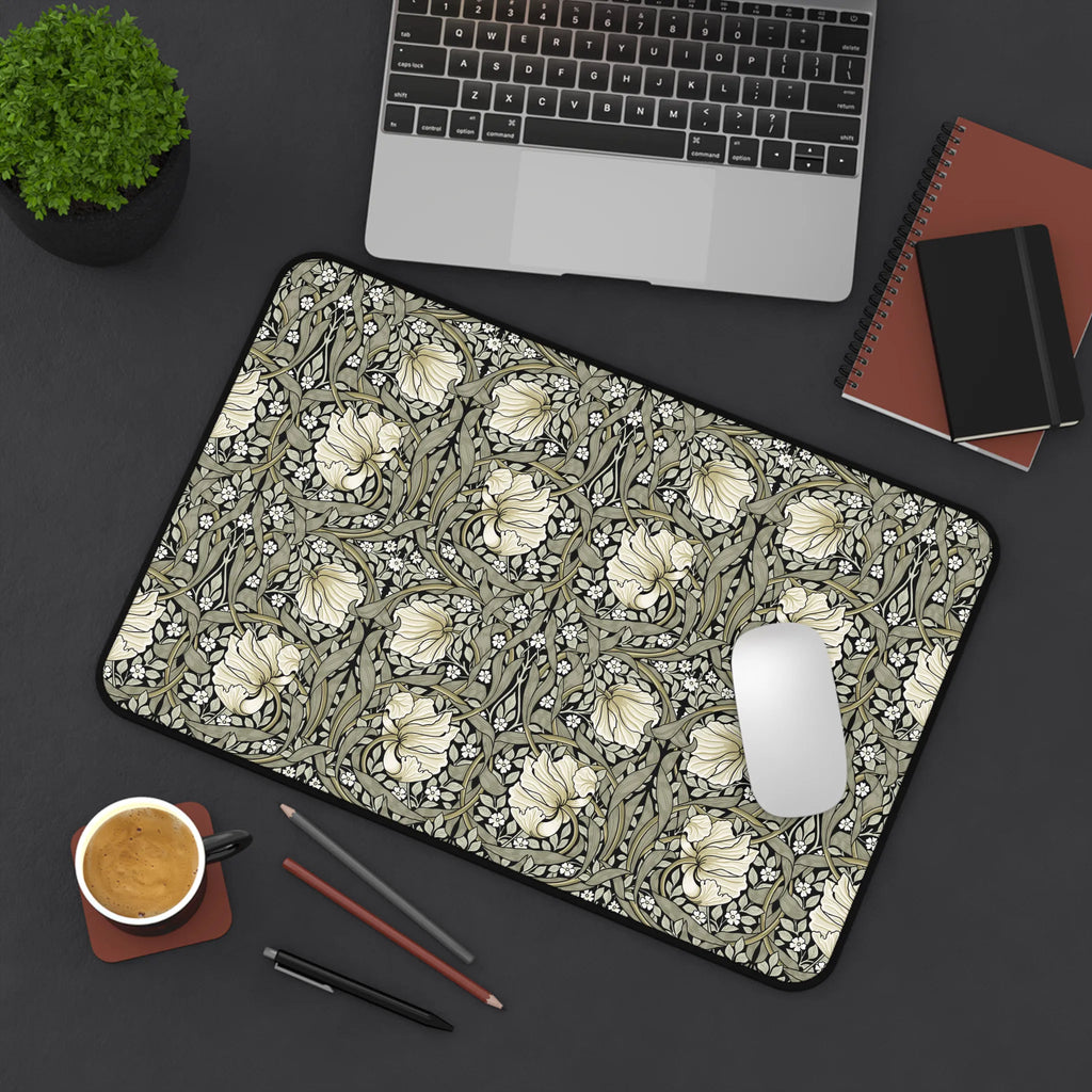 William Morris desk mat on a desk with laptop, notebook, and coffee cup.