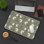 William Morris desk mat on a desk with laptop, notebook, and coffee cup.