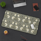 Floral patterned William Morris desk pad on a dark surface with office items.