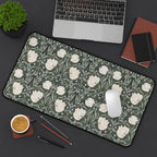 Floral patterned William Morris desk mat mouse pad on a desk with laptop, coffee, and stationery items.