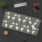 Large floral patterned William Morris desk mat on a dark surface with office items.