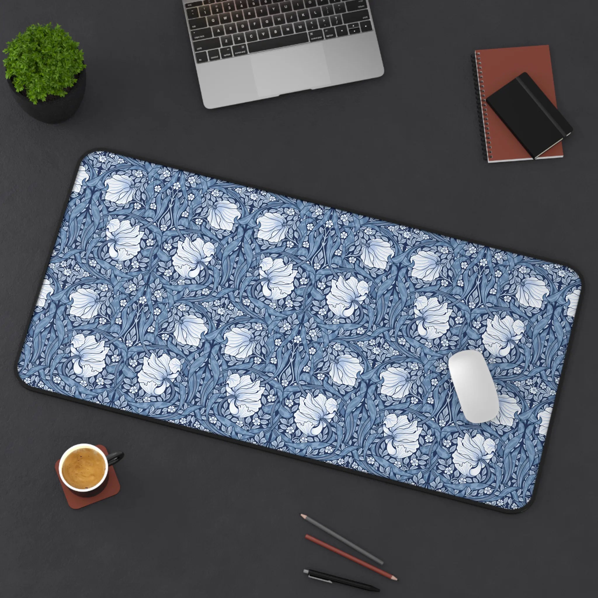 William Morris desk mat on a dark surface with office items, featuring blue Pimpernel design