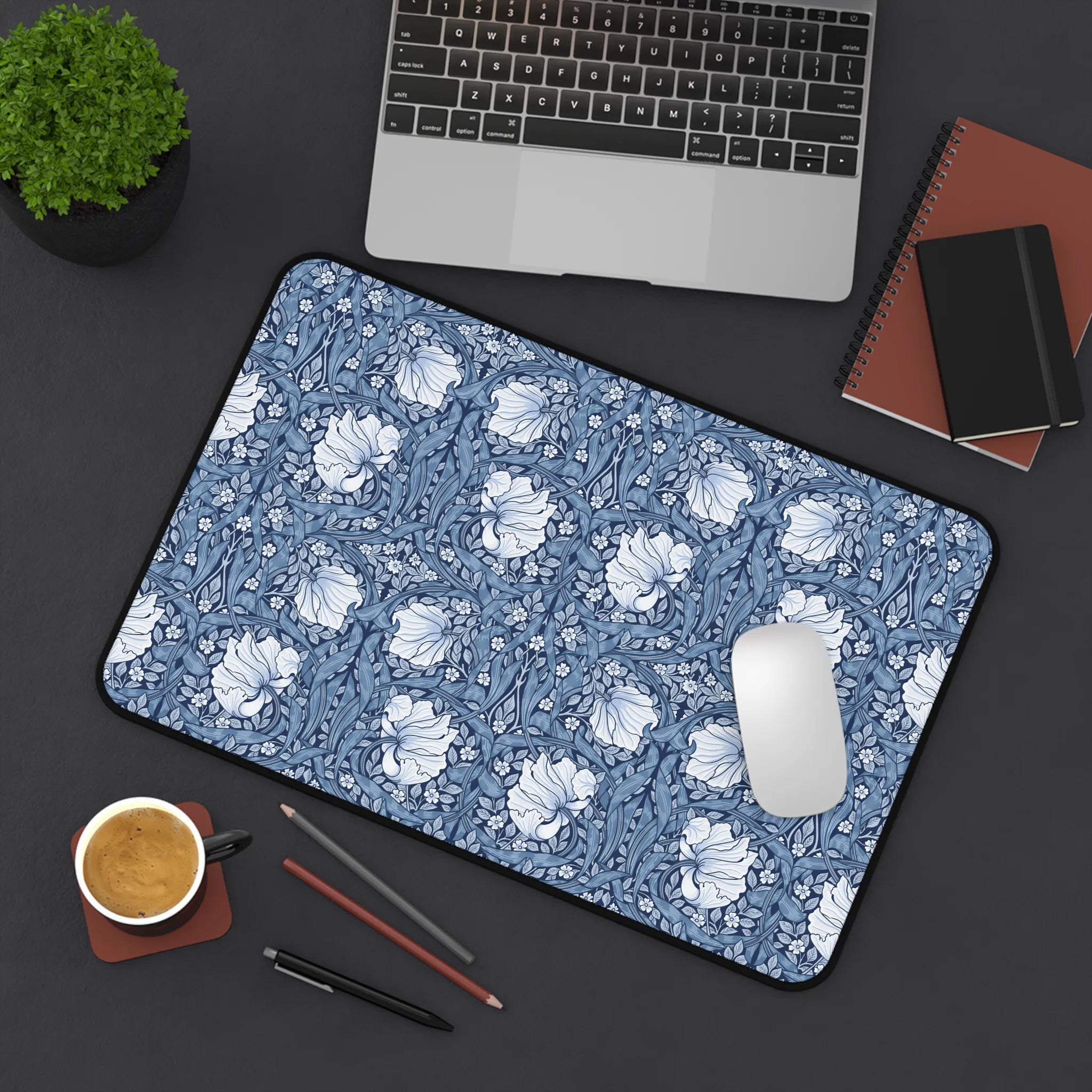 William Morris desk pad with blue Pimpernel pattern on a desk with laptop, notebook, and coffee cup.