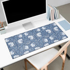 Floral patterned blue Pimpernel William Morris desk mat on a white desk with a computer setup