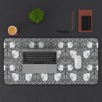 Decorative William Morris Pimpernel desk mat with floral pattern, keyboard, cup, plant, and stationery items on a dark surface.