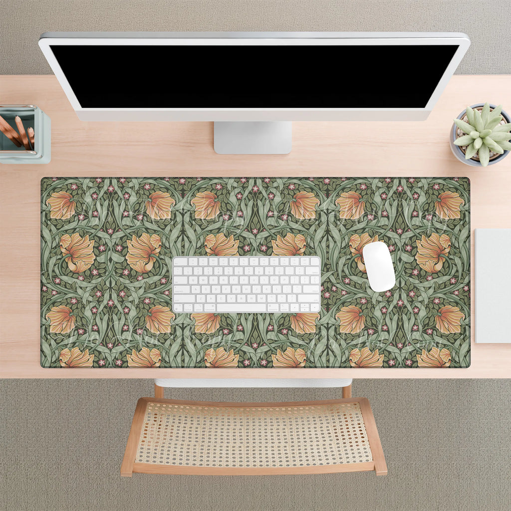 A desk setup with a large William Morris desk mat featuring the iconic Pimpernel pattern in sage green and copper