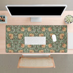 A desk setup with a large William Morris desk mat featuring the iconic Pimpernel pattern in sage green and copper