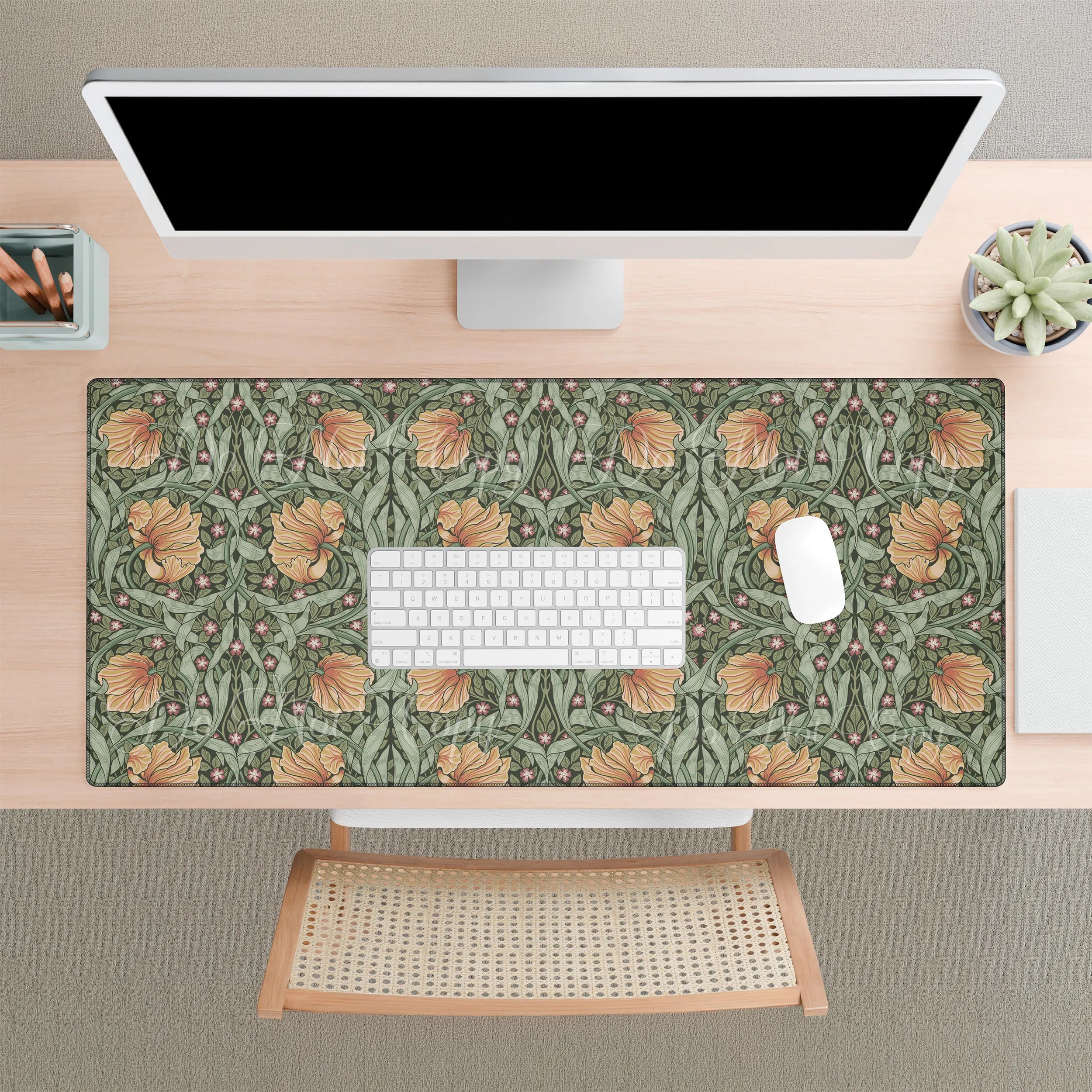 A desk setup with a large William Morris desk mat featuring the iconic Pimpernel pattern in sage green and copper