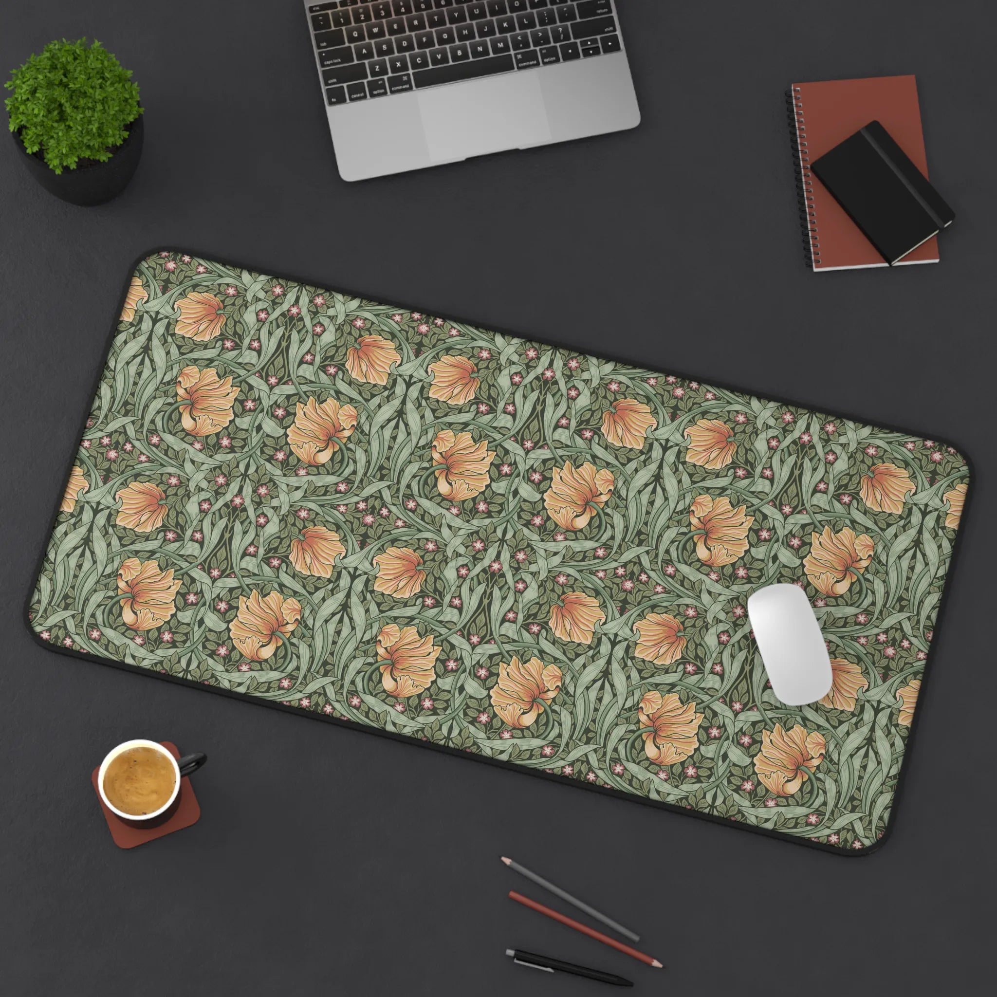 Large William Morris desk mat mouse pad on a dark surface with laptop, cup, and stationery items.
