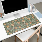Floral patterned William Morris Pimpernel desk mat on a desk with a computer setup