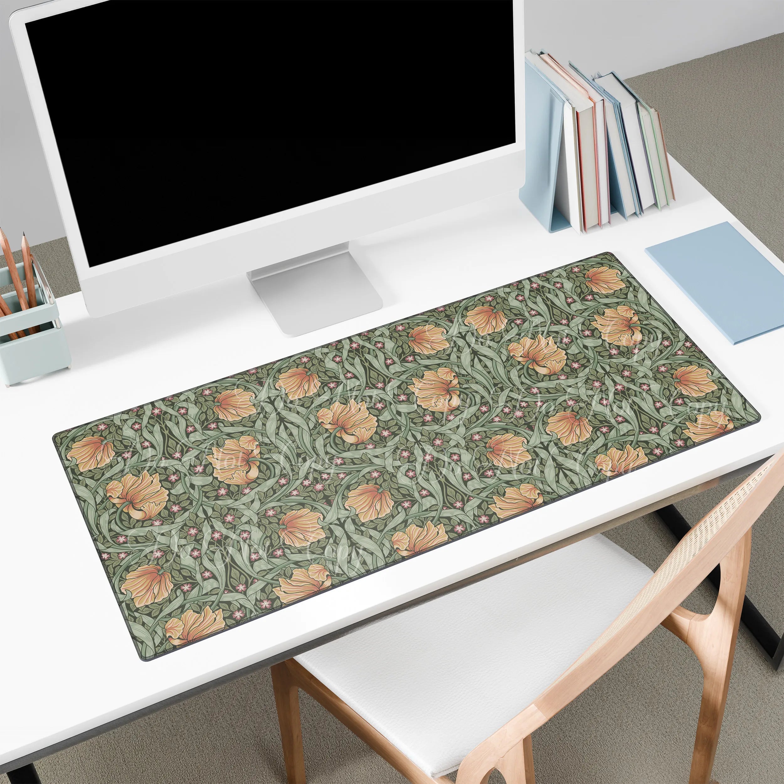 Floral patterned William Morris Pimpernel desk mat on a desk with a computer setup