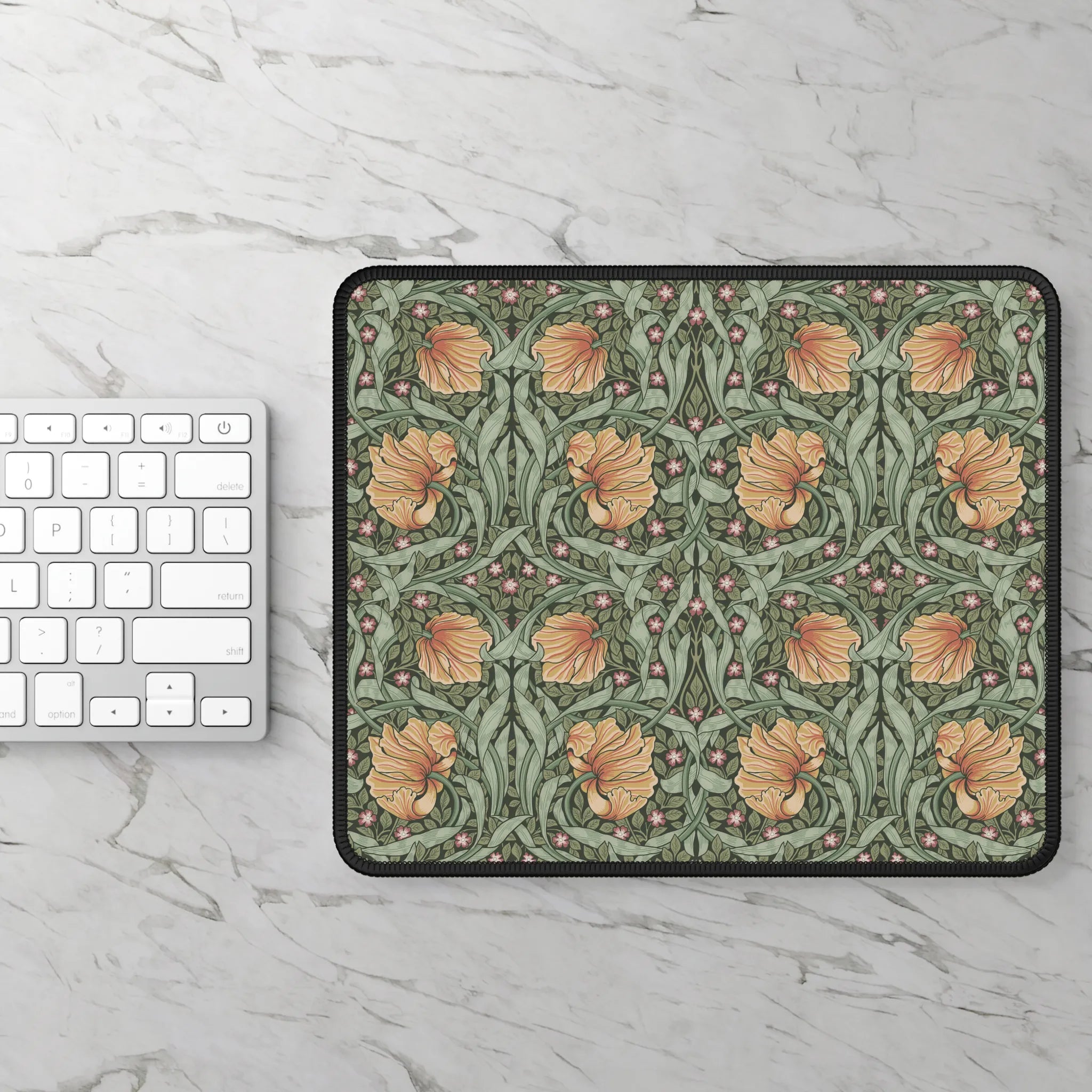 Floral patterned William Morris mouse pad on a marble surface with a keyboard.