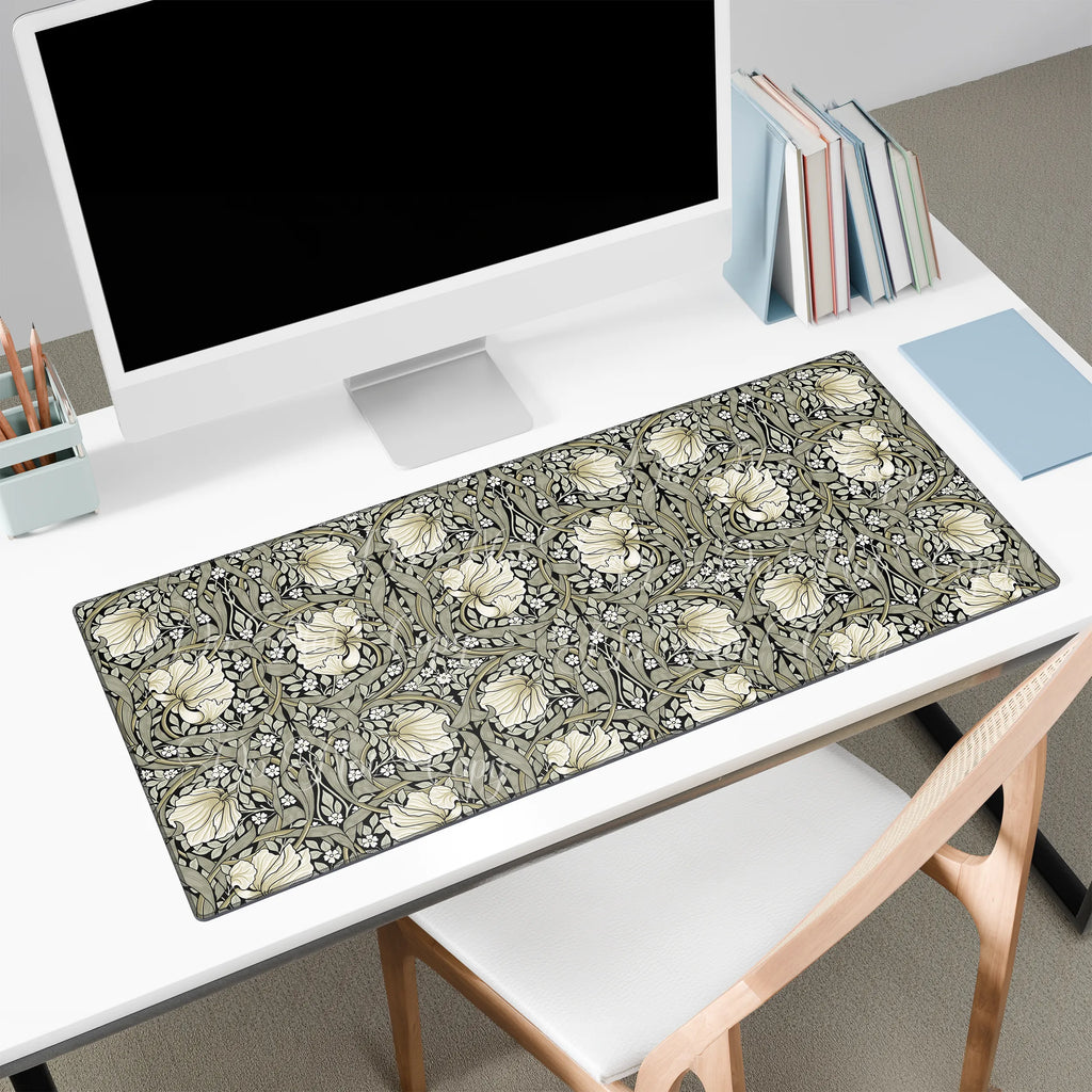 Floral patterned Willioam Morris desk mat on a desk with a computer setup