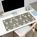 Floral patterned Willioam Morris desk mat on a desk with a computer setup