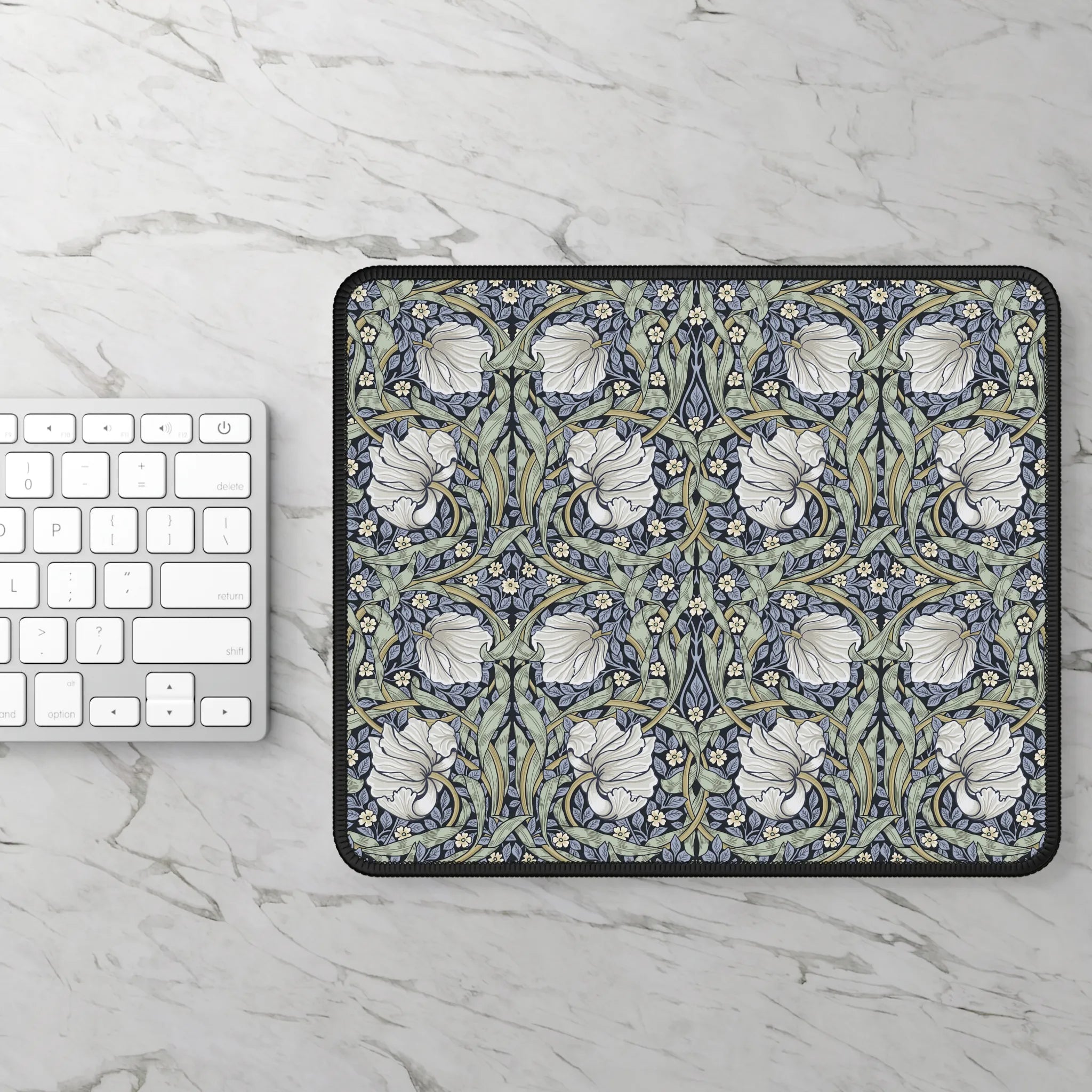 Floral patterned William Morris mouse pad on a marble surface with a keyboard.