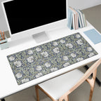 Floral patterned Pimpernel William Morris desk mat on a desk with a computer setup