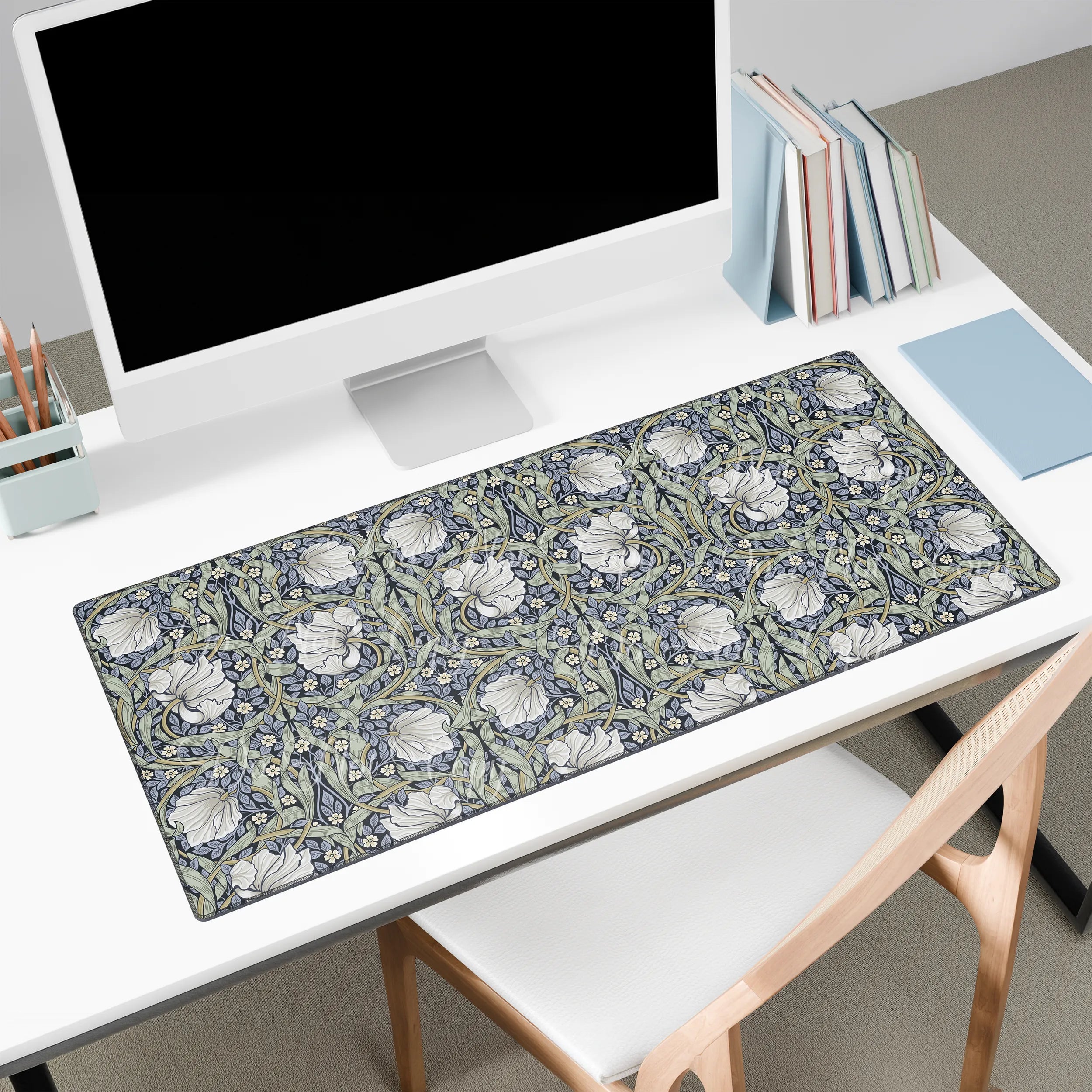 Floral patterned Pimpernel William Morris desk mat on a desk with a computer setup