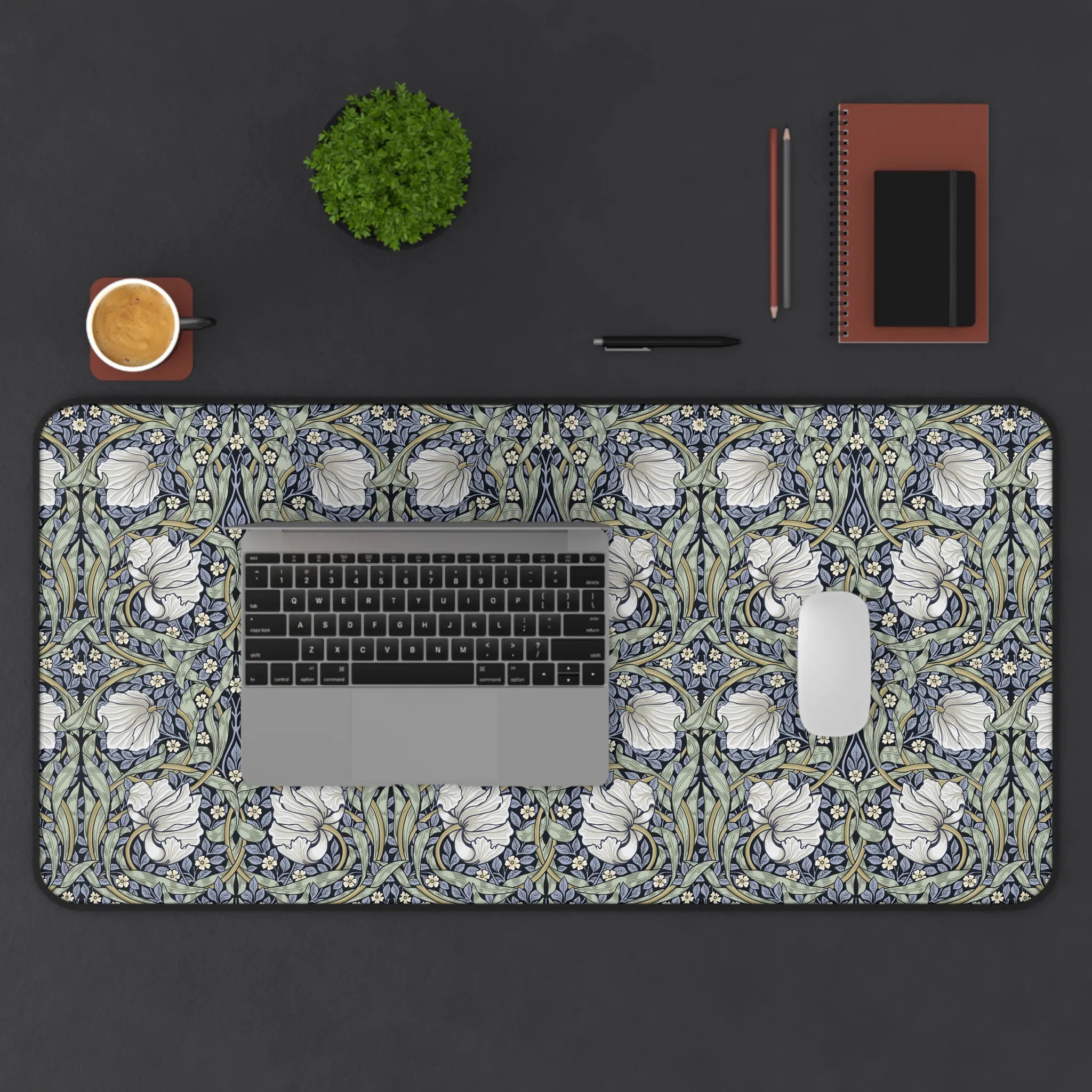 Decorative William Morris desk mat with floral Pimpernel pattern on a dark surface with office items.