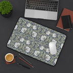 William Morris desk pad with Pimpernel pattern on a desk with laptop, notebook, and coffee cup.