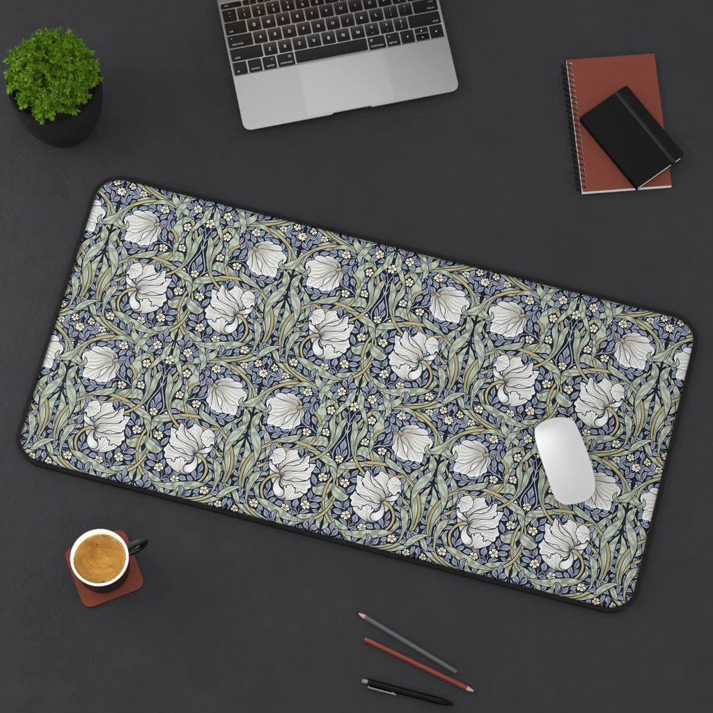 Floral patterned William Morris Pimpernel desk mat on a dark surface with office items.