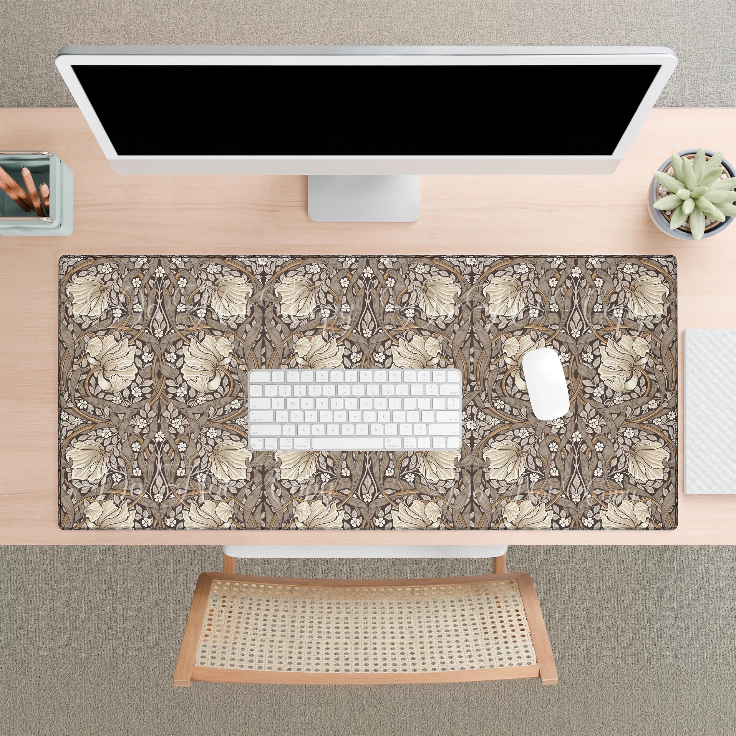 Floral patterned William Morris Pimpernel desk mat on a desk with a computer setup