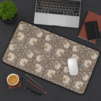 Floral patterned William Morris desk mat mouse pad on a desk with laptop, notebook, and coffee cup.
