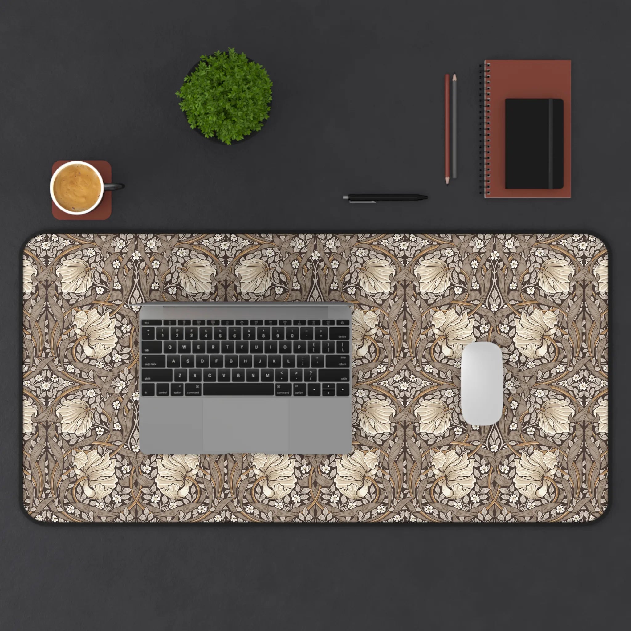 Decorative William Morris desk mat with laptop, mouse, and office supplies on a dark surface