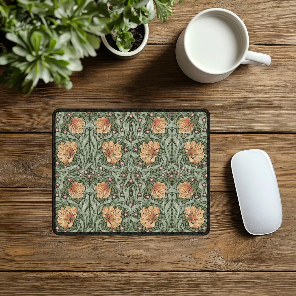 Pimpernel mouse pad on a wooden desk with a mug and plant.