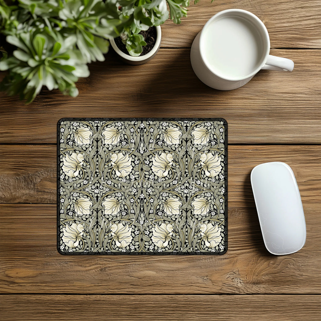 Decorative William Morris Pimpernel mouse pad with floral pattern on a wooden desk with a mug and plant.