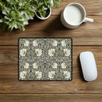 Decorative William Morris Pimpernel mouse pad with floral pattern on a wooden desk with a mug and plant.