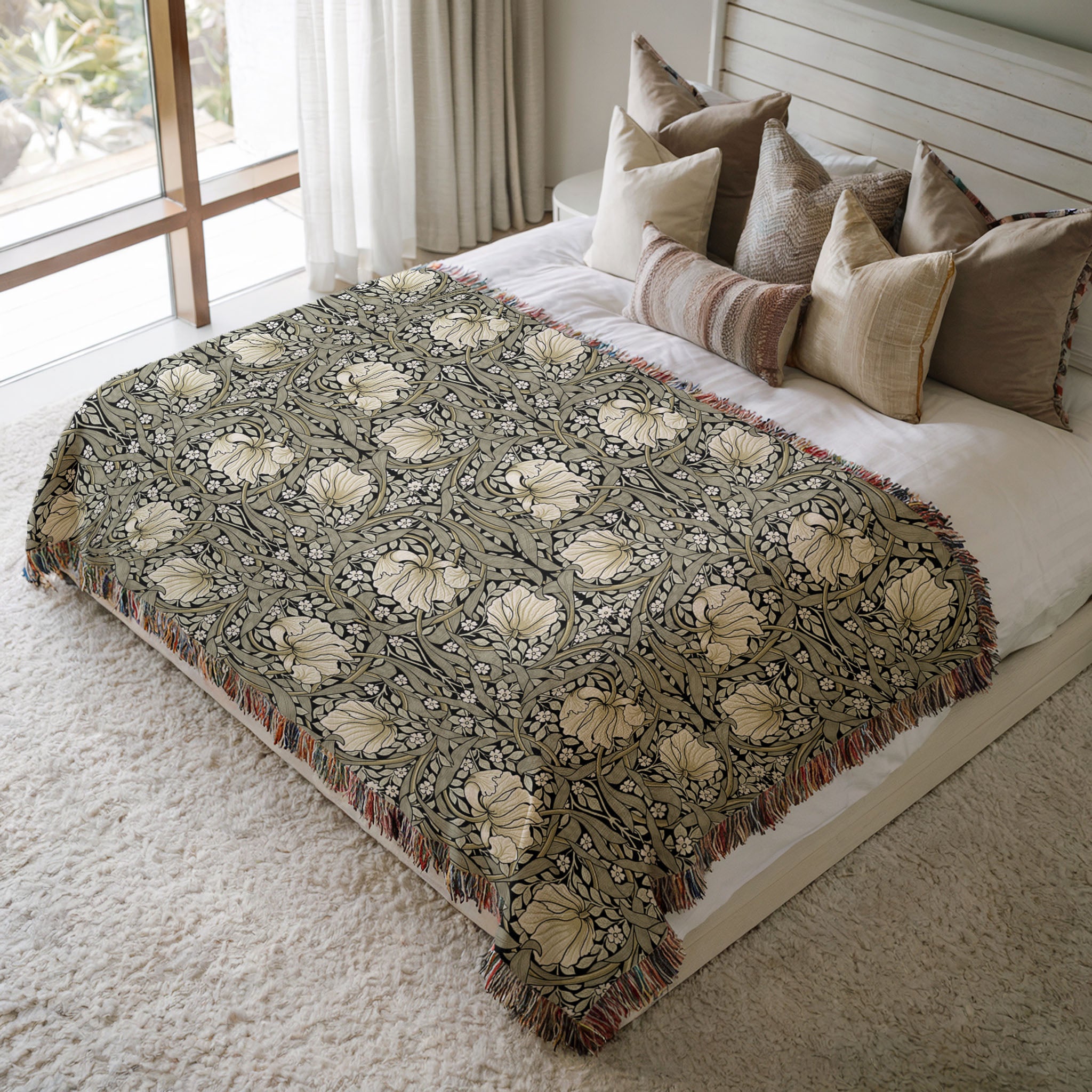 William Morris Pimpernel woven blanket styled on bed, soft botanical throw adding texture to cozy bedroom decor, in sage green and cream on ebony