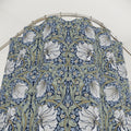 William Morris shower curtain in blue and sage green Pimpernel pattern on a metal hoop against a white background