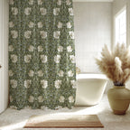 Bathroom with a William Morris Pimpernel shower curtain, white bathtub, and decorative vase with pampas grass.