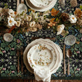 William Morris Blackthorn tablecloth in Dramatic Black featuring an intricate Arts and Crafts botanical pattern, styled for heritage revival dining tables and English country decor.