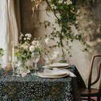 William Morris Blackthorn tablecloth in classic black with intricate vines and floral motifs, styled for cottagecore tablescapes and English country dining rooms.