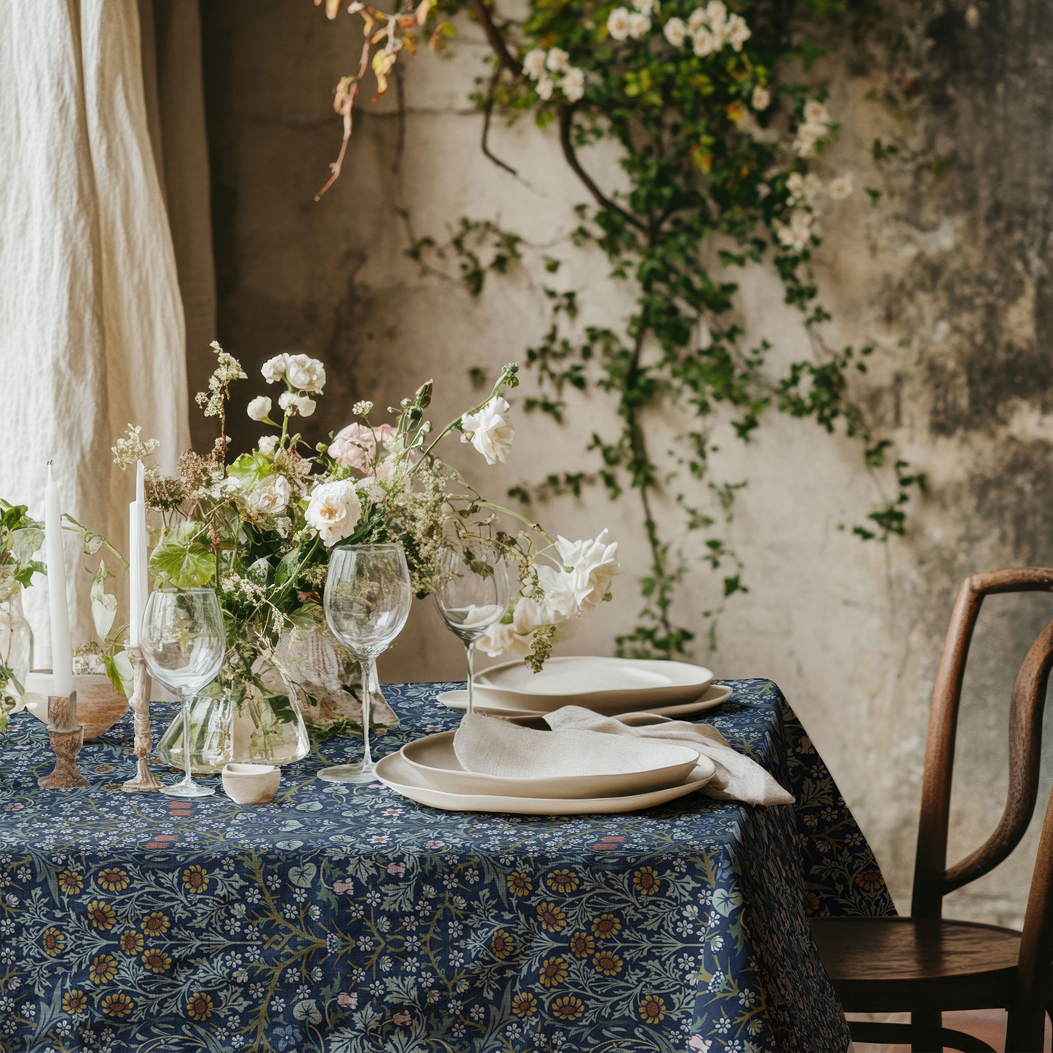 William Morris Blackthorn tablecloth in blue featuring an intricate Arts and Crafts botanical pattern, styled for heritage revival dining tables and English country decor.