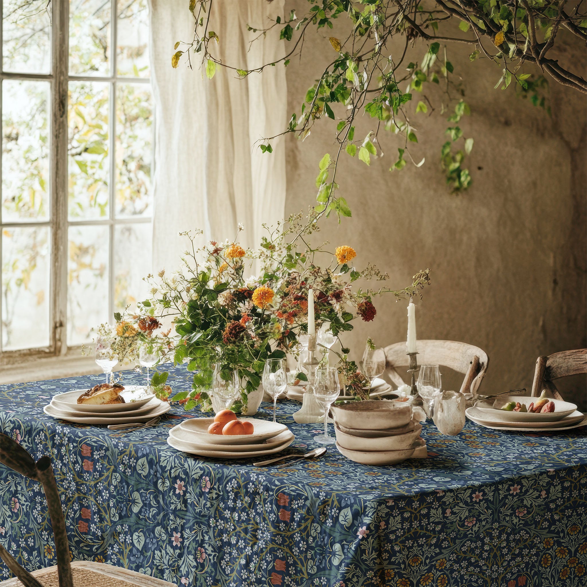 William Morris Blackthorn tablecloth in blue with intricate vines and floral motifs, styled for cottagecore tablescapes and English country dining rooms.