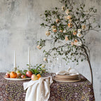 William Morris Blackthorn tablecloth in maroon with intricate vines and floral motifs, styled for cottagecore tablescapes and English country dining rooms.