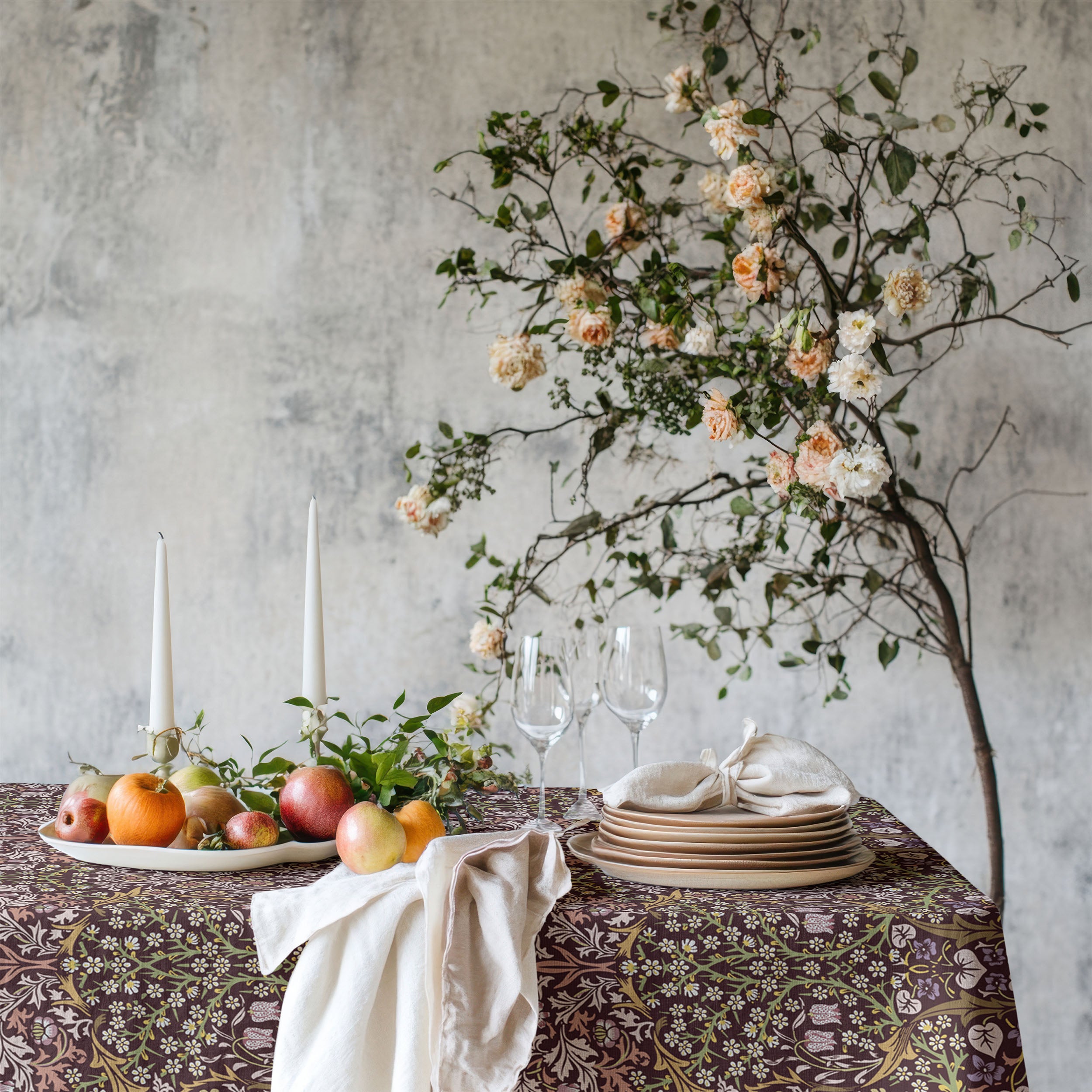 William Morris Blackthorn tablecloth in maroon with intricate vines and floral motifs, styled for cottagecore tablescapes and English country dining rooms.