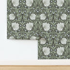William Morris Pimpernel wallpaper shown partially installed on a wall, highlighting the repeating botanical pattern from the iconic Arts and Crafts design.