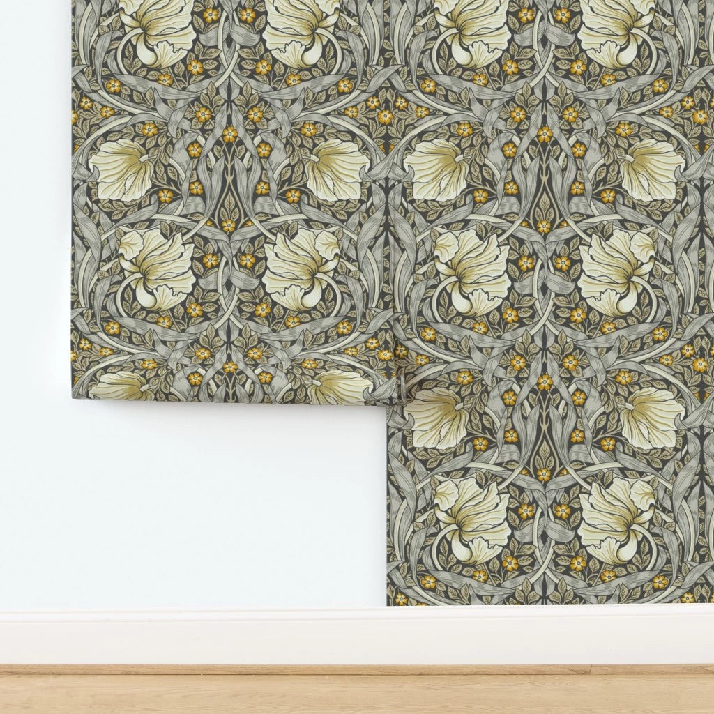 William Morris Pimpernel wallpaper shown partially installed on a wall, highlighting the repeating botanical pattern from the iconic Arts and Crafts design.