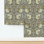 William Morris Pimpernel wallpaper in Heritage Greige and Ochre shown partially installed on a wall.