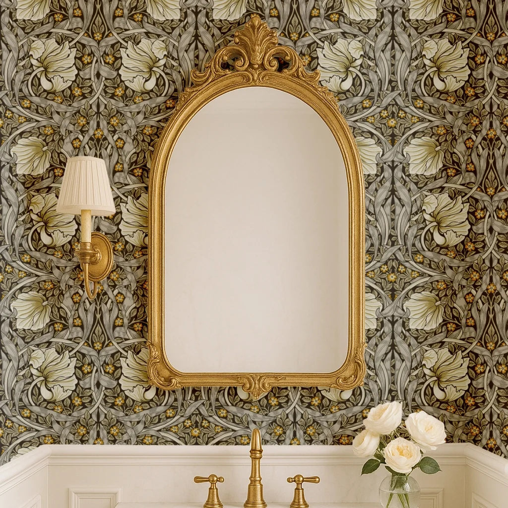 Bathroom with ornate mirror against William Morris Pimpernel wallpaper in Heritage Greige and Ochre.