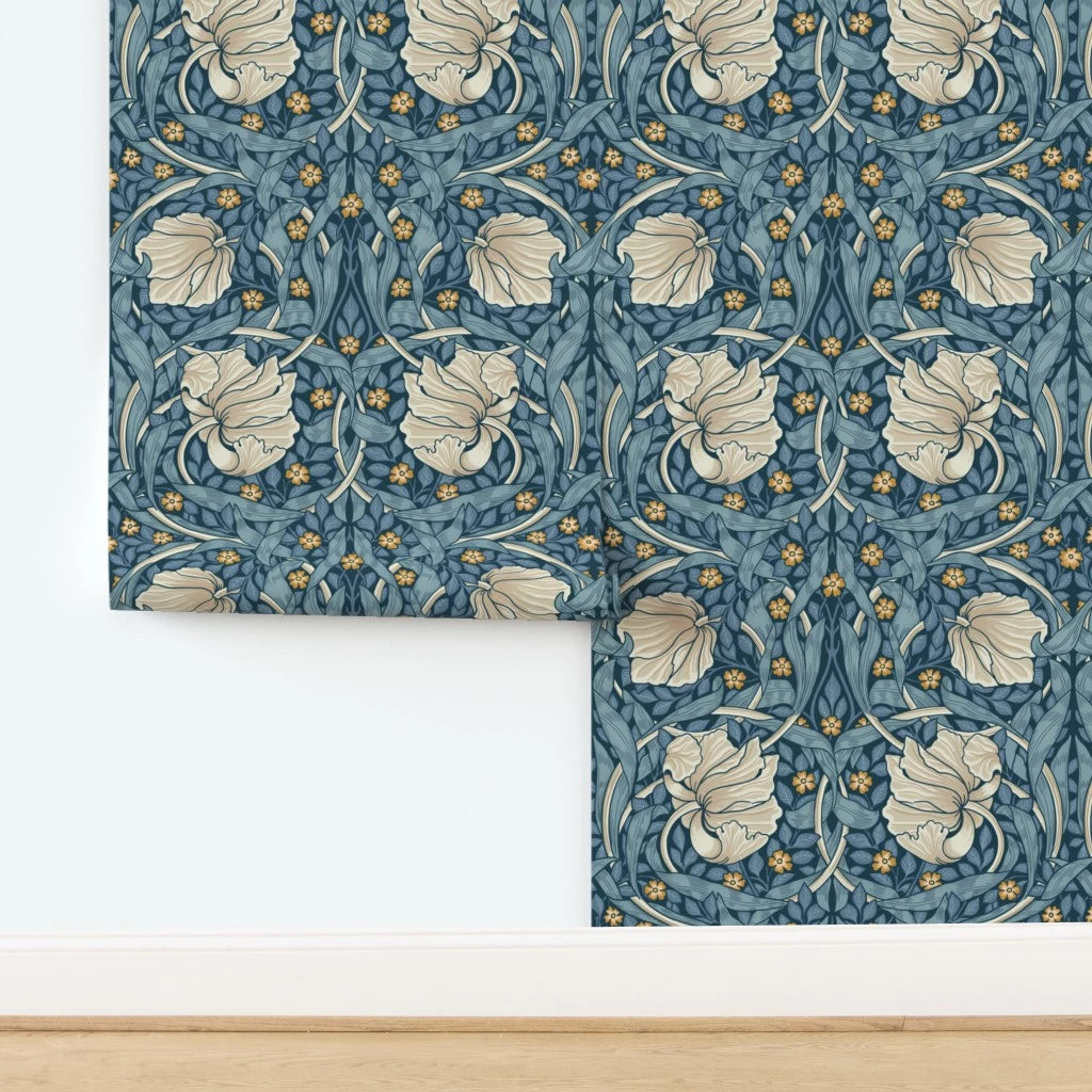 Floral patterned William Morris Pimpernel wallpaper in blue shown on wall