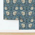 Floral patterned William Morris Pimpernel wallpaper in blue shown on wall