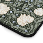 Floral patterned William Morris mouse pad  closeup with white flowers and green leaves on a dark background
